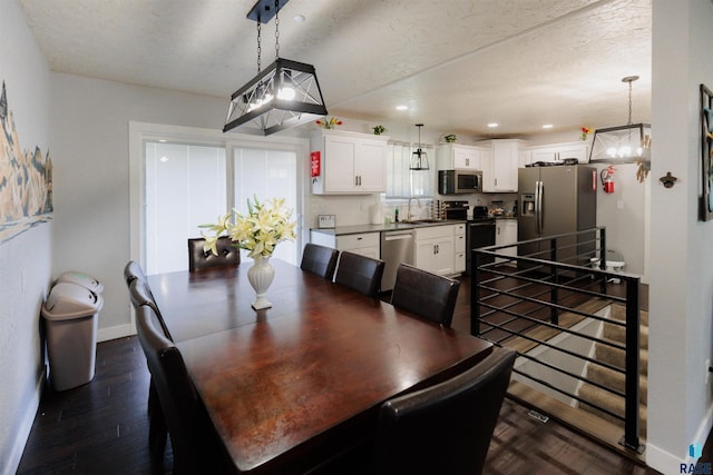 dining room with recessed lighting, a textured ceiling, baseboards, and dark wood-style flooring