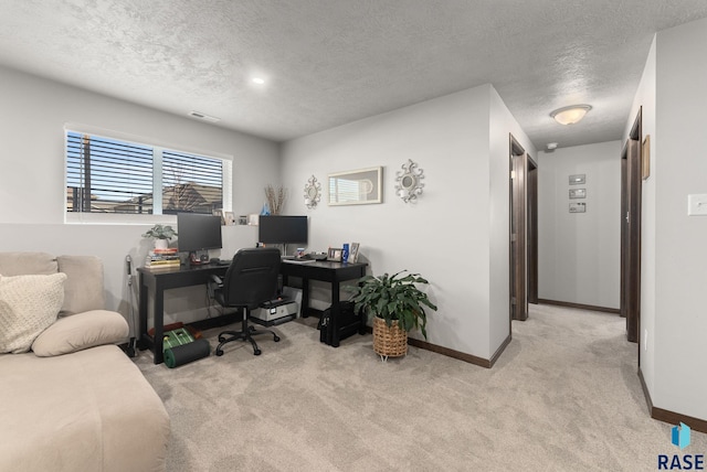 office space featuring visible vents, carpet, baseboards, and a textured ceiling