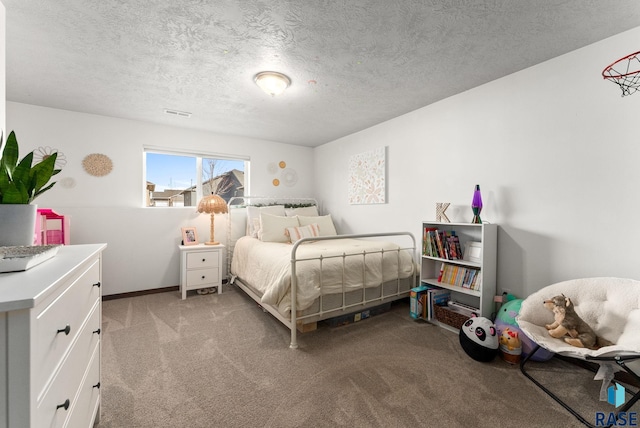 bedroom with visible vents, light colored carpet, and a textured ceiling