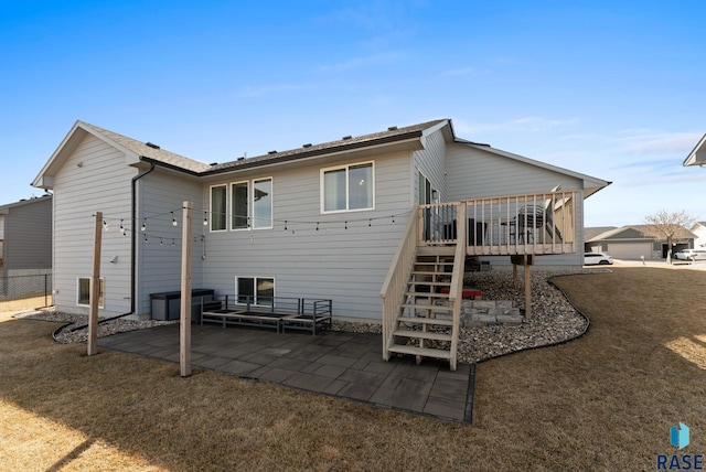 rear view of property featuring a patio, fence, a yard, a wooden deck, and stairs