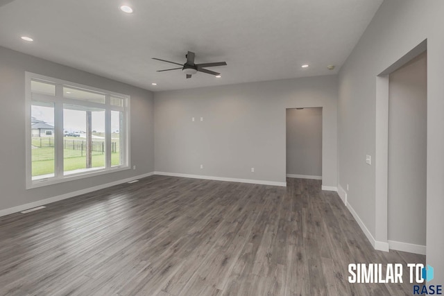 empty room featuring recessed lighting, baseboards, and wood finished floors