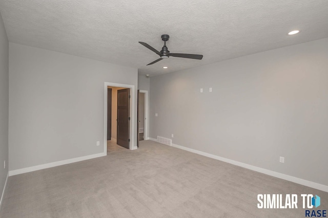 empty room featuring visible vents, recessed lighting, baseboards, and light carpet