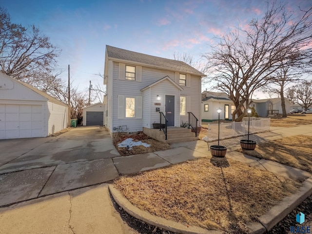 colonial home featuring an outbuilding, fence, and a garage