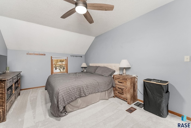 bedroom with baseboards, lofted ceiling, light colored carpet, and a textured ceiling