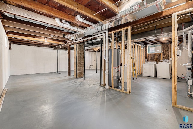 basement with gas water heater and washing machine and clothes dryer