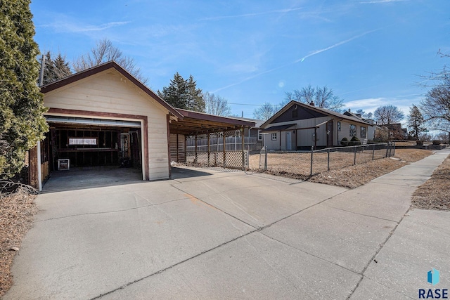 view of side of home with a garage, an outbuilding, and fence