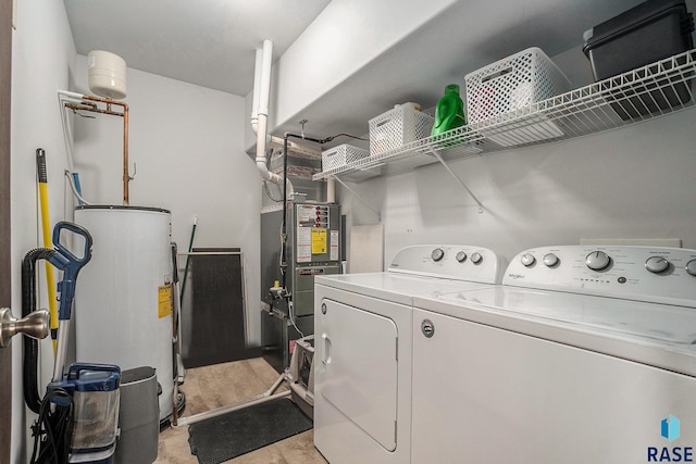 laundry area featuring laundry area, washer and clothes dryer, and electric water heater