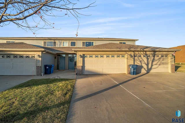 view of front of house with brick siding, driveway, and a garage