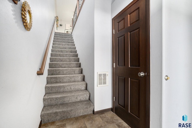 staircase featuring visible vents and baseboards