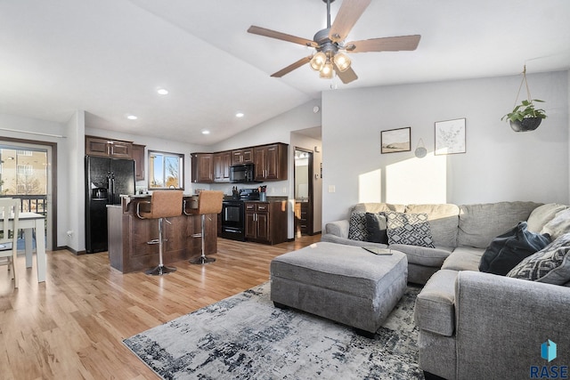 living room featuring lofted ceiling, recessed lighting, light wood finished floors, and ceiling fan