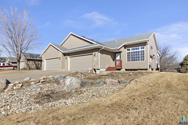 single story home featuring an attached garage, concrete driveway, and roof with shingles