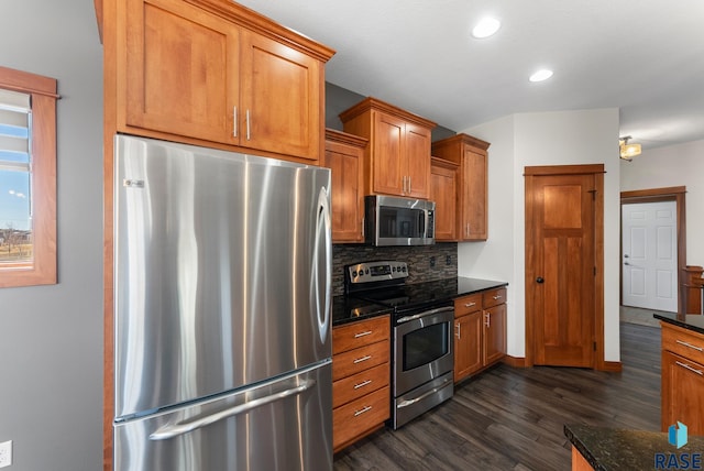 kitchen featuring dark wood-style flooring, tasteful backsplash, appliances with stainless steel finishes, and brown cabinets