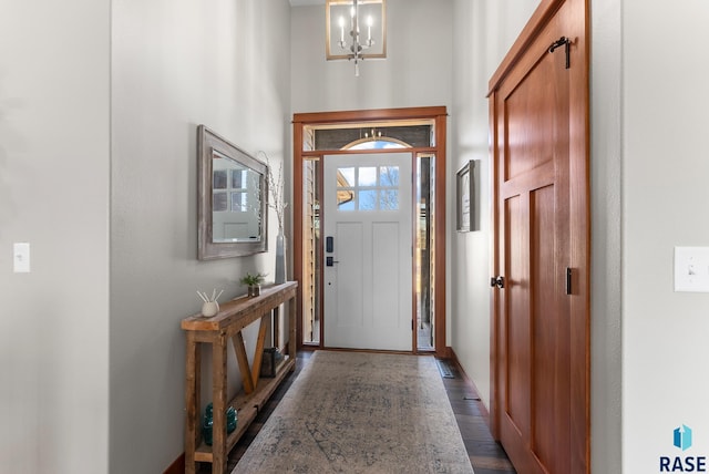 foyer featuring a notable chandelier and dark wood-style flooring