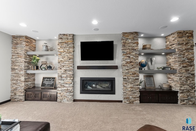 living area with recessed lighting, baseboards, carpet floors, and a glass covered fireplace