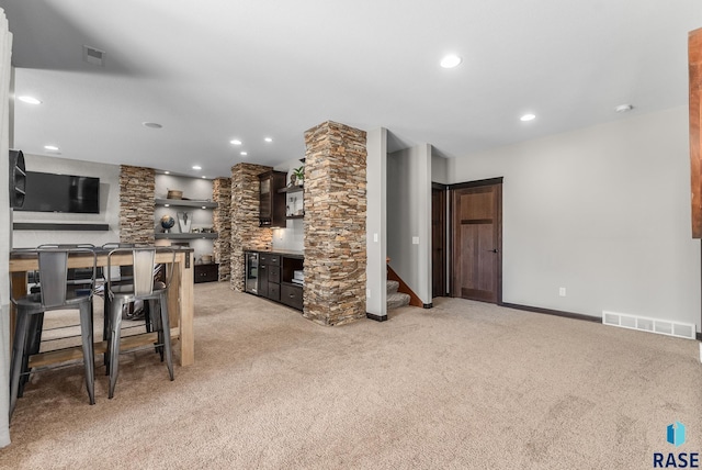 interior space with recessed lighting, visible vents, light colored carpet, and stairs