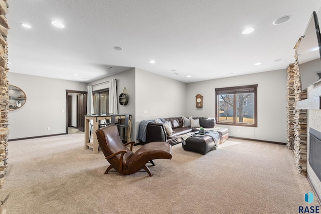 living room featuring recessed lighting, a fireplace, light colored carpet, and baseboards