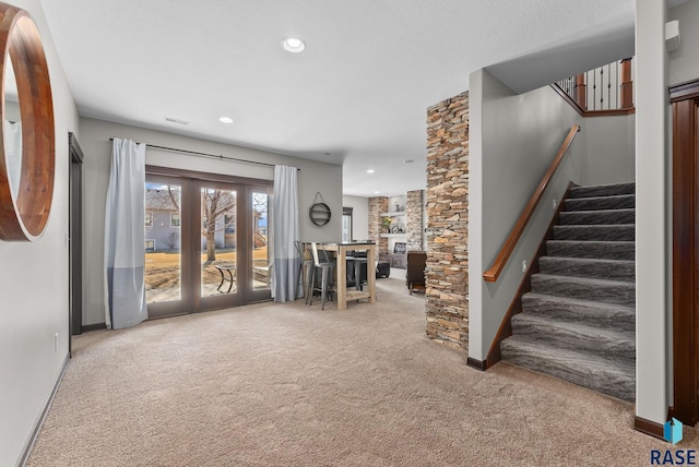 interior space with visible vents, recessed lighting, stairway, carpet flooring, and baseboards