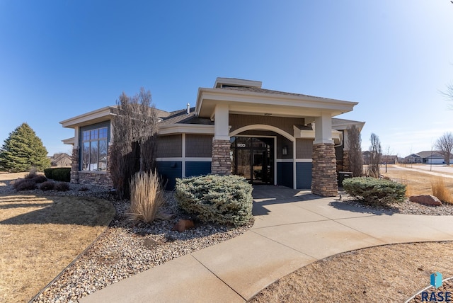 exterior space featuring stone siding