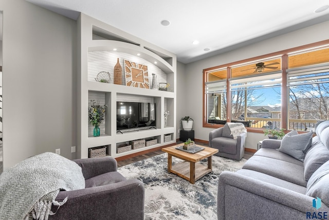 living area featuring built in features, recessed lighting, baseboards, and wood finished floors