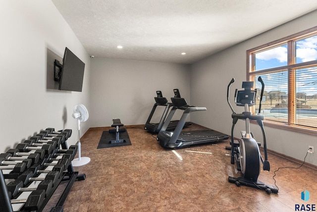 workout room with recessed lighting, baseboards, and a textured ceiling