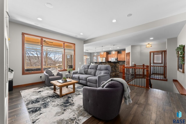 living room featuring recessed lighting, baseboards, and dark wood-style flooring