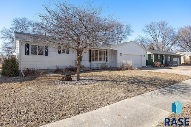 ranch-style home with a porch, driveway, and a garage