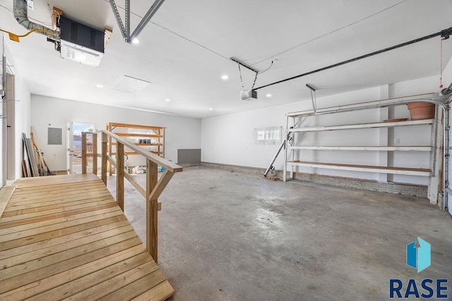 garage featuring electric panel and a garage door opener