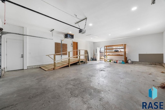 garage with recessed lighting and a garage door opener