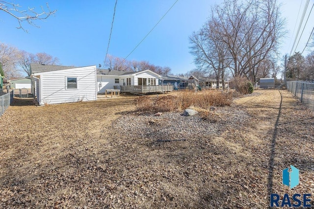 rear view of property featuring fence