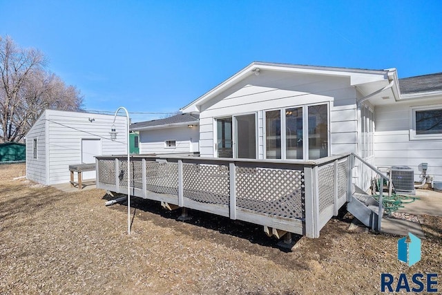 back of property with central air condition unit and a wooden deck