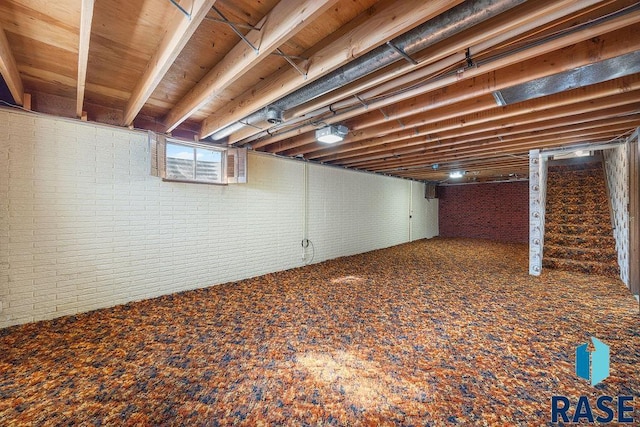 basement with brick wall