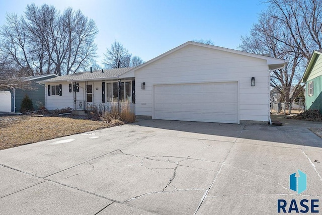 ranch-style home featuring concrete driveway and an attached garage