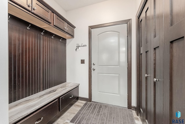 mudroom with baseboards and light wood finished floors