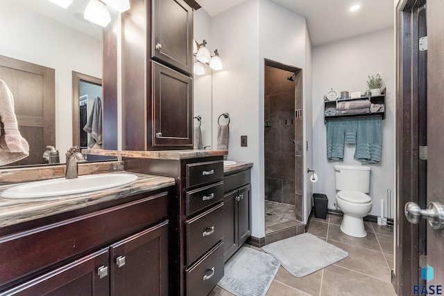 bathroom featuring tile patterned floors, toilet, a stall shower, and vanity