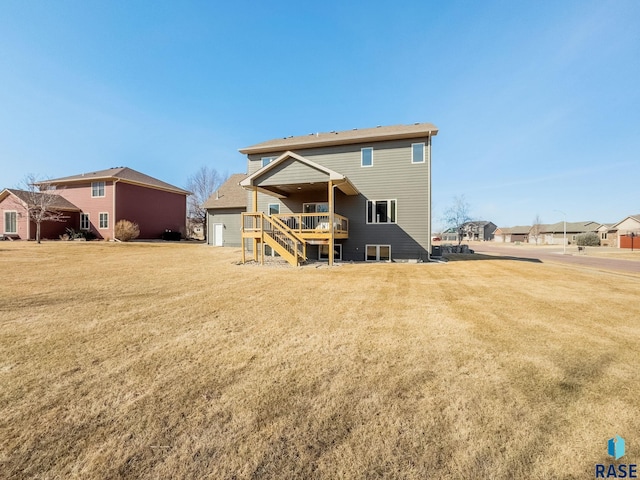 back of house featuring a deck, stairway, and a yard