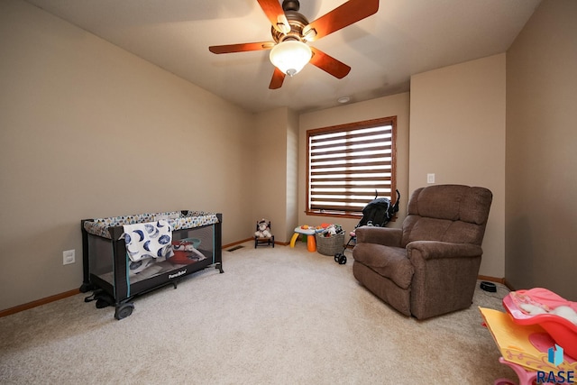 sitting room with visible vents, baseboards, carpet, and ceiling fan