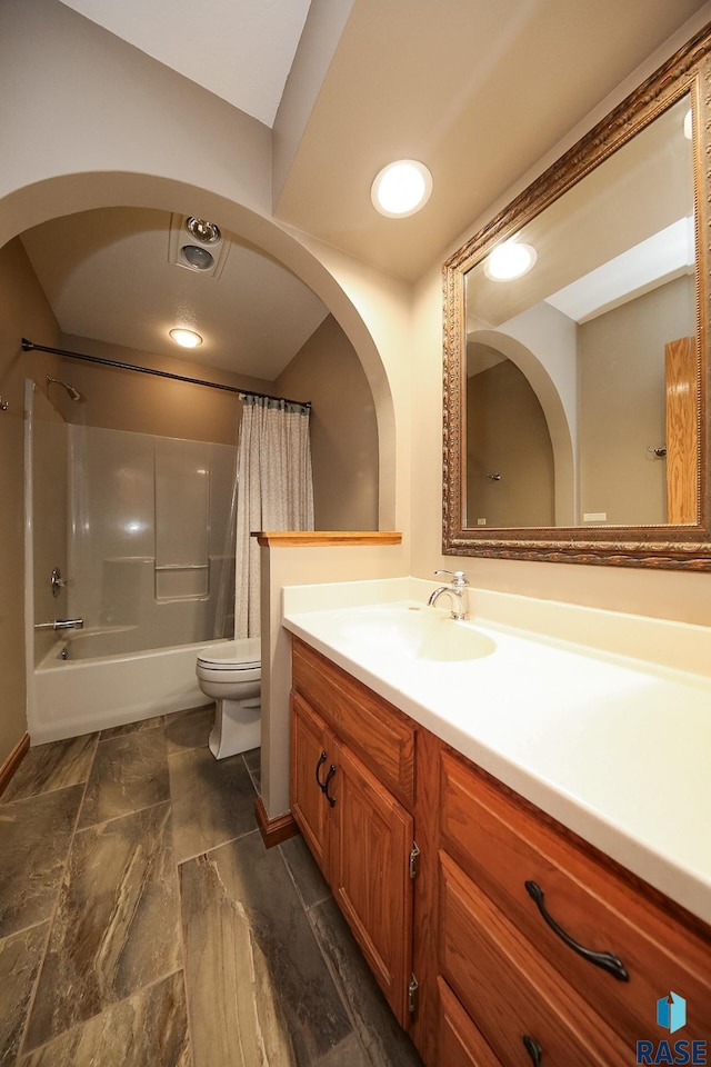 bathroom featuring recessed lighting, shower / tub combo, toilet, and vanity