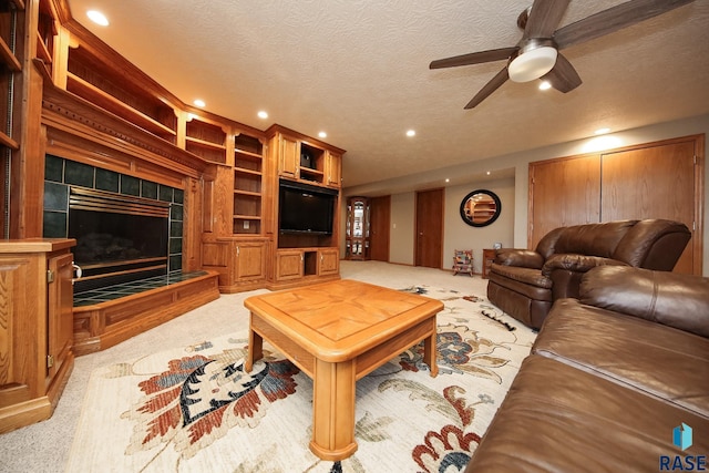 living room with recessed lighting, light carpet, a textured ceiling, and a tiled fireplace