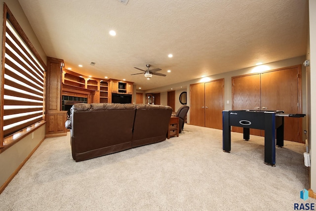 interior space with recessed lighting, light carpet, a textured ceiling, and a fireplace