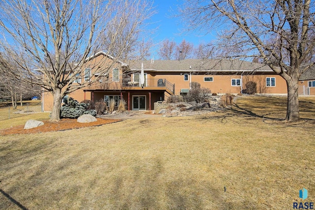 rear view of house with a yard and a deck