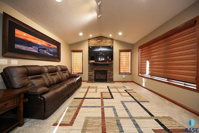 living room featuring a textured ceiling, a fireplace, baseboards, light colored carpet, and vaulted ceiling