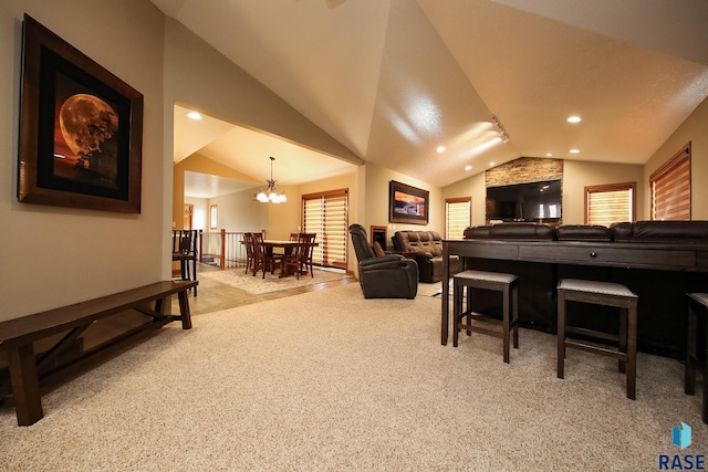 carpeted living room featuring lofted ceiling, recessed lighting, and a chandelier