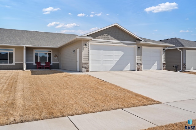 ranch-style house with a garage, stone siding, a front yard, and driveway