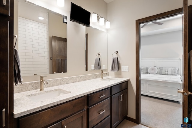 ensuite bathroom featuring a sink, visible vents, ensuite bath, and double vanity