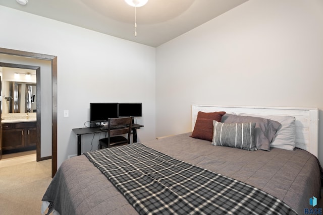 bedroom featuring light colored carpet and ensuite bath