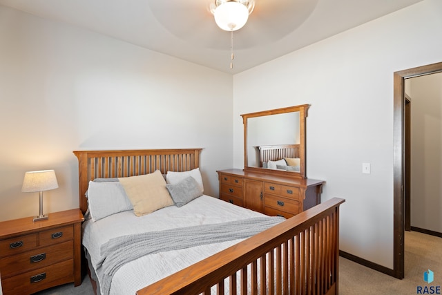 bedroom featuring baseboards and light carpet