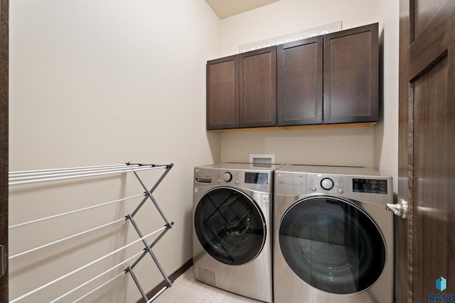 laundry room featuring cabinet space, independent washer and dryer, and baseboards