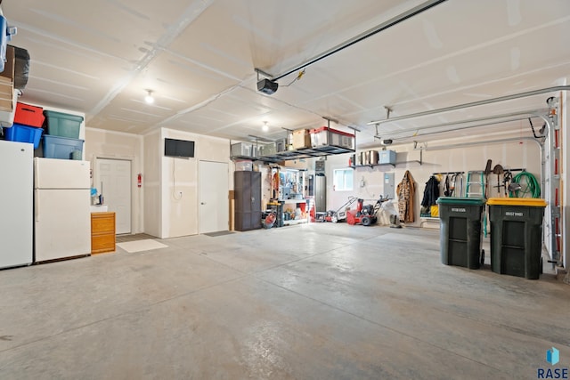 garage with a garage door opener and freestanding refrigerator