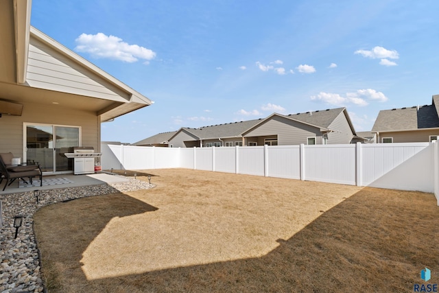 view of yard with a patio area and a fenced backyard