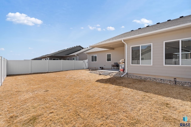 view of yard with a fenced backyard and a patio